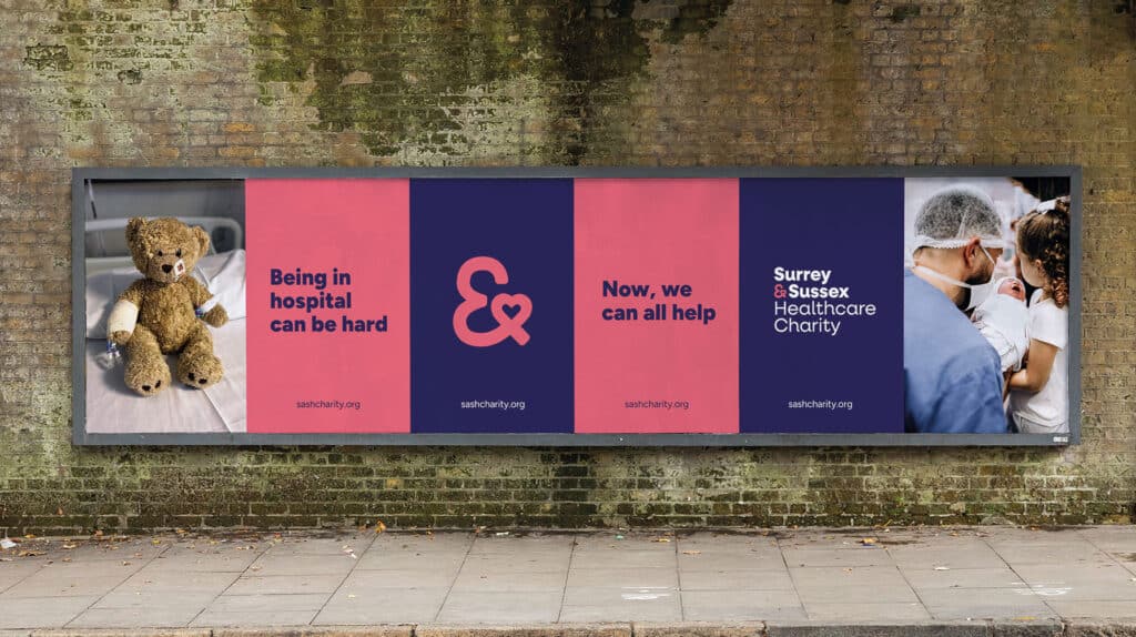 Outdoor billboard for Surrey and Sussex Healthcare Charity featuring a hospital teddy bear, bold messages about hospital hardship and community support, and an image of a newborn with family and a doctor.