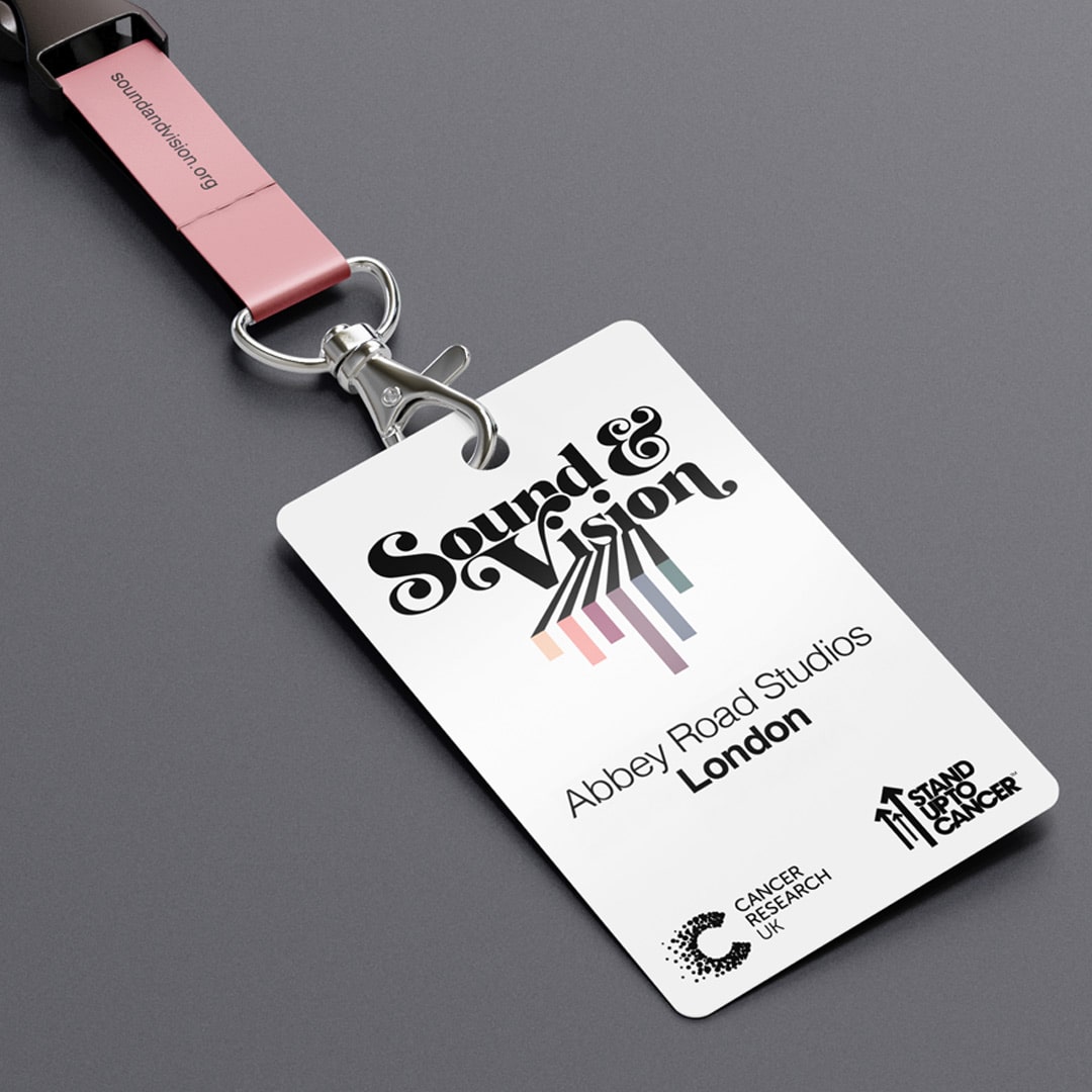 Lanyard and event pass for Sound & Vision at Abbey Road Studios, featuring bold retro-style typography and pastel graphic lines. Created for a Cancer Research UK and Stand Up To Cancer fundraiser.”