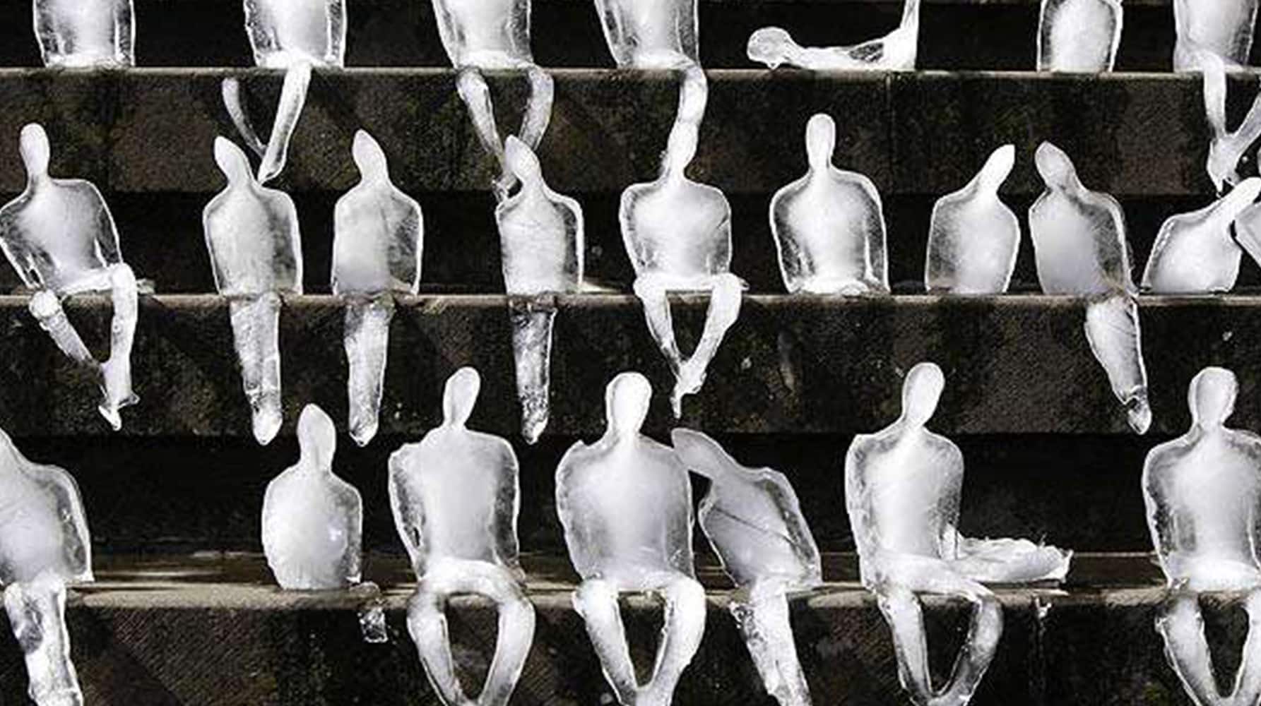 Ice sculptures shaped like seated human figures arranged on steps.