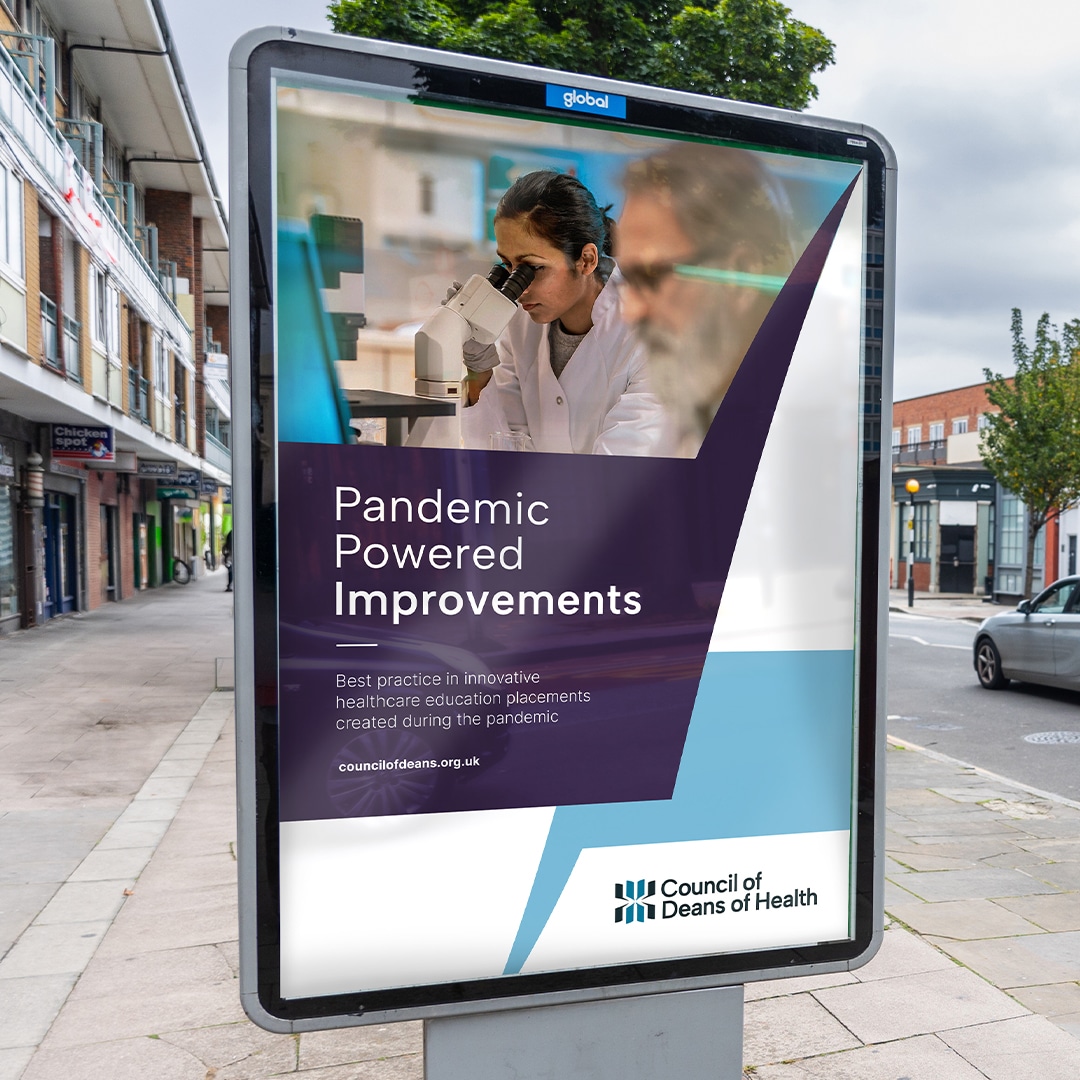 Billboard-style advert in a street for the Council of Deans of Health, featuring a female scientist using a microscope with the headline: “Pandemic Powered Improvements.”